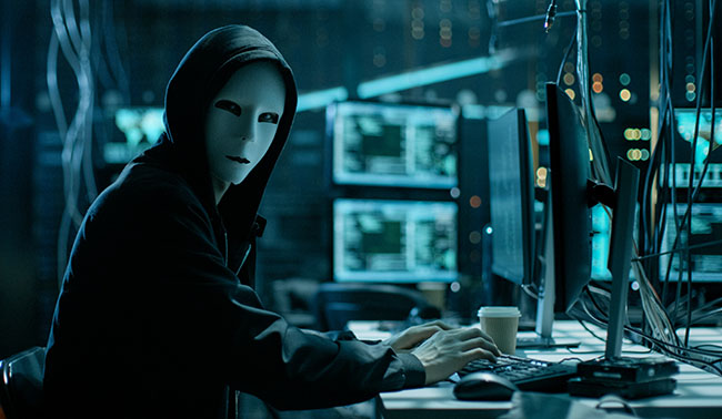 Masked Hacker Is Using Computer For Organizing Massive Data Breach Attack On Corporate Servers They 039 Re In Underground Secret Location Surrounded By Displays And Cables