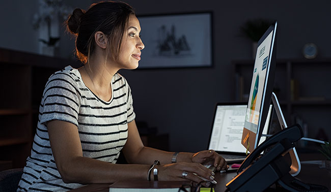 Casual Woman Working Late At Computer