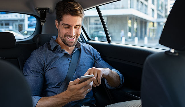 Happy Business Man In Car Using Phone
